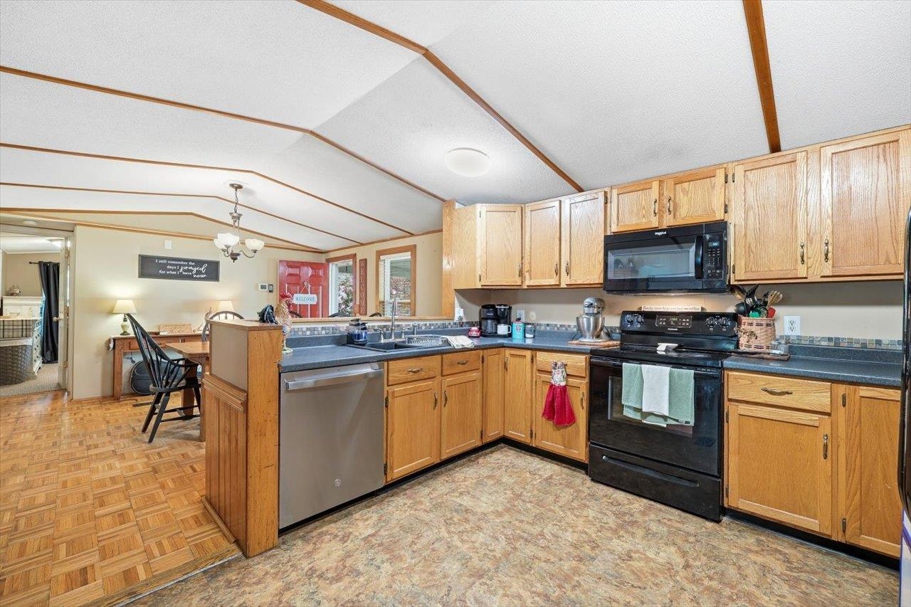 406 Trayfoot Road Grottoes, VA 24441 - Photo 8 of 30 a kitchen with stainless steel appliances granite countertop a stove top oven a sink a dining table and chairs with wooden floor