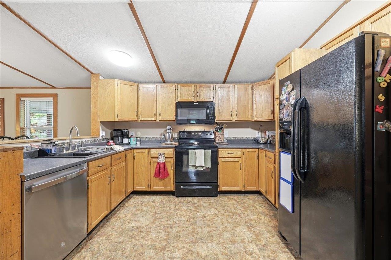 406 Trayfoot Road Grottoes, VA 24441 - Photo 9 of 30 a kitchen with stainless steel appliances granite countertop a stove top oven a sink and a refrigerator