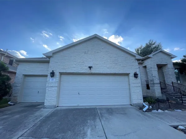 a view of a house with a small yard and wooden floor and fence