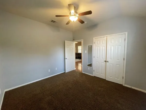 a view of a livingroom with a ceiling fan and window