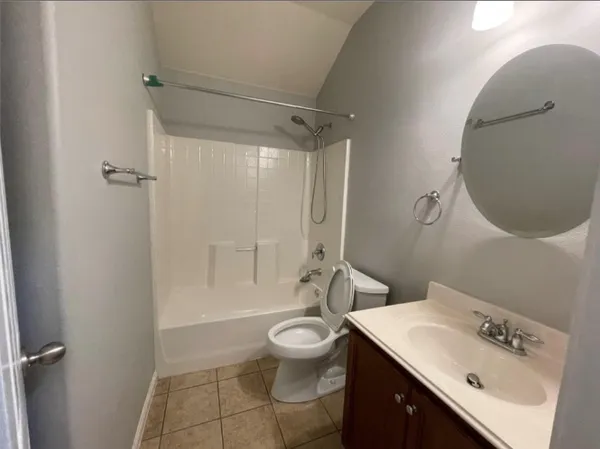 a spacious bathroom with double vanity and a mirror