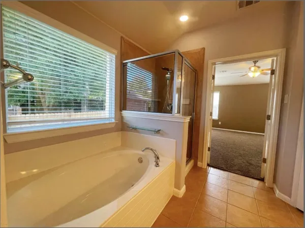 a view of a swimming pool with lawn chairs under an umbrella