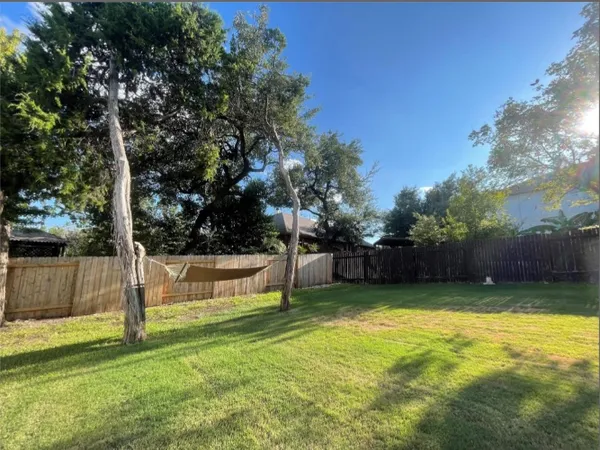a view of a backyard with swimming pool