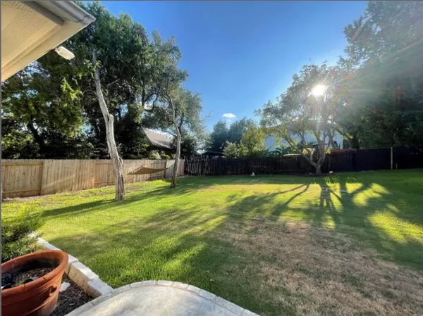 a view of house with backyard space and garden