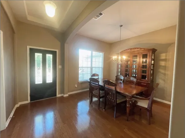 a living room with a couch and chandelier