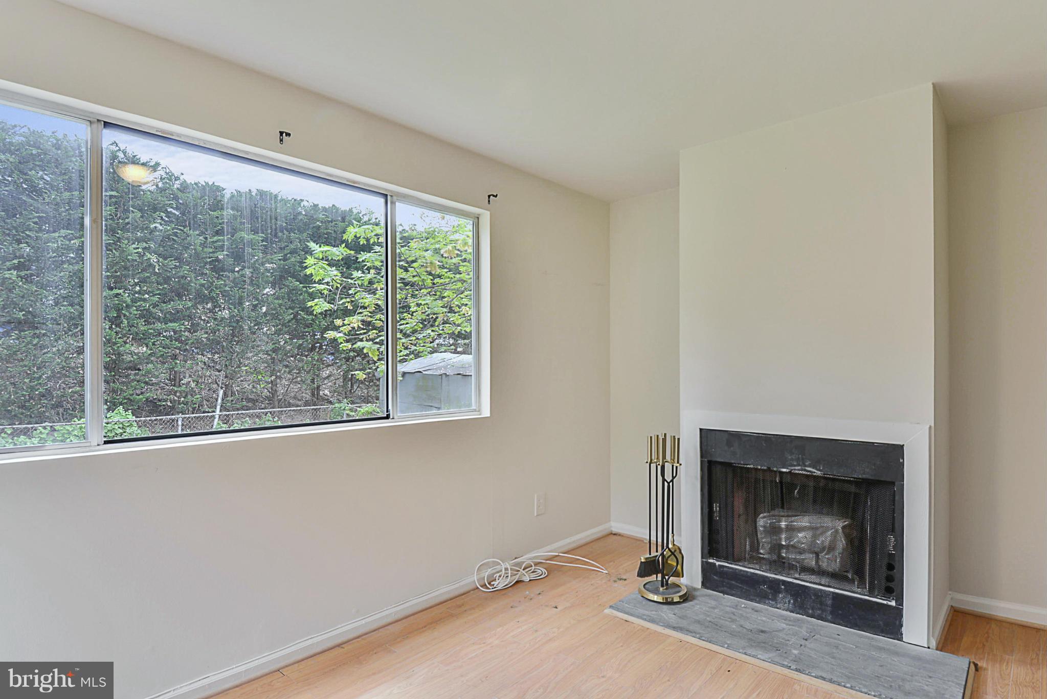 2800 Denley Place Silver Spring, MD 20906 - Photo 9 of 26 a view of an empty room with a fireplace and a window
