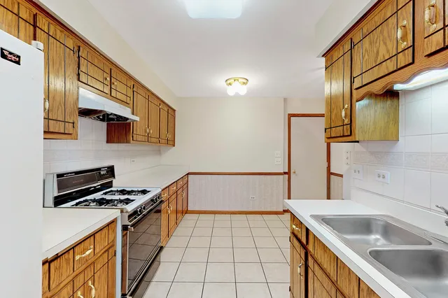 a kitchen with a sink a stove and a microwave