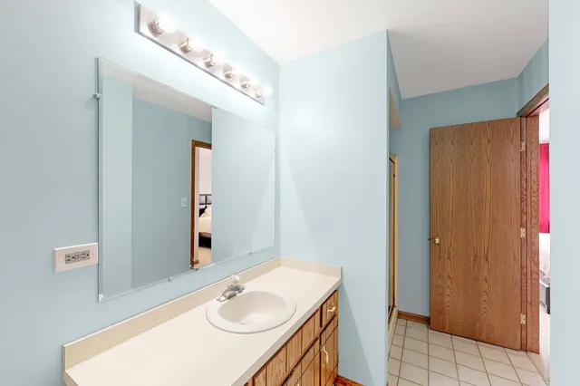a bathroom with a sink vanity and a mirror