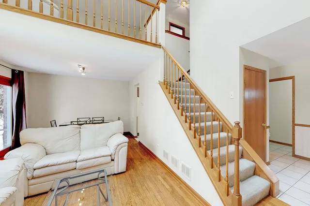 a living room with furniture and stairs
