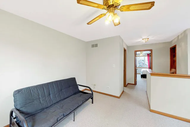 a living room with furniture and a ceiling fan