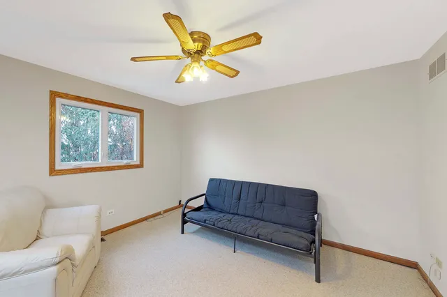 a living room with a couch and a potted plant