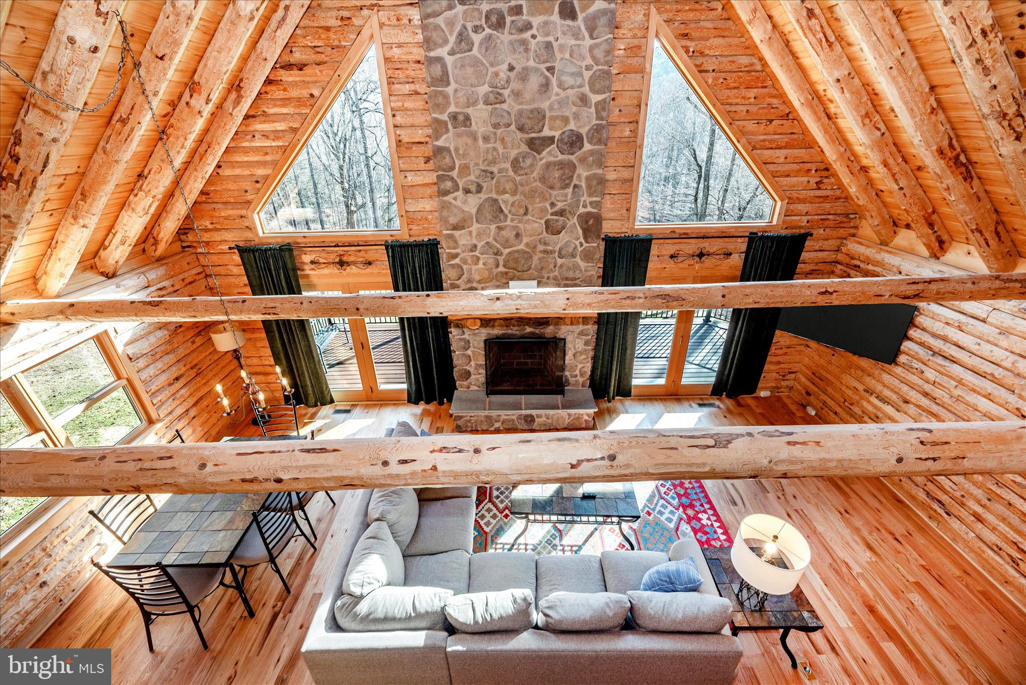 12804 Spruce Run Road Myersville, MD 21773 - Photo 19 of 72 a living room with furniture and a fireplace