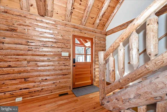 a view of a patio with couches and table potted plants with wooden floor