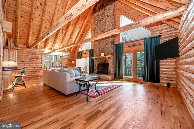 a view of a patio with table and chairs with wooden floor and fence