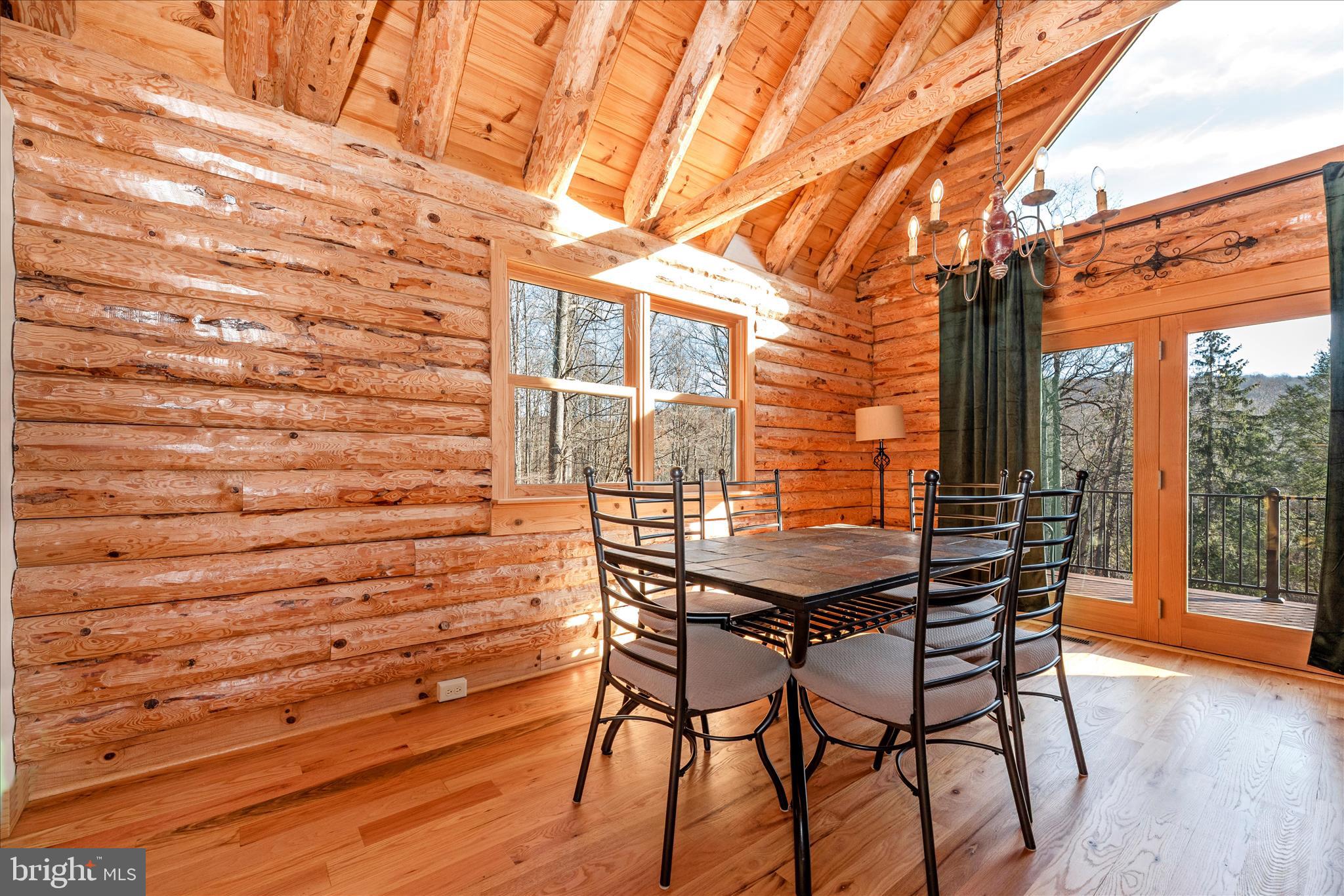 12804 Spruce Run Road Myersville, MD 21773 - Photo 7 of 72 a view of a patio with table and chairs with wooden floor and fence