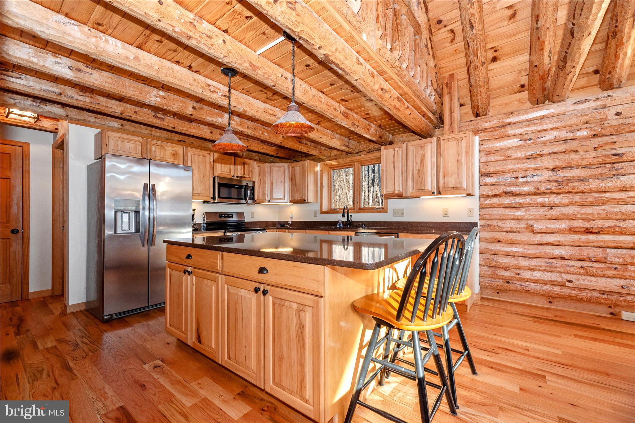 12804 Spruce Run Road Myersville, MD 21773 - Photo 10 of 72 a kitchen with stainless steel appliances granite countertop a table chairs and wooden floor