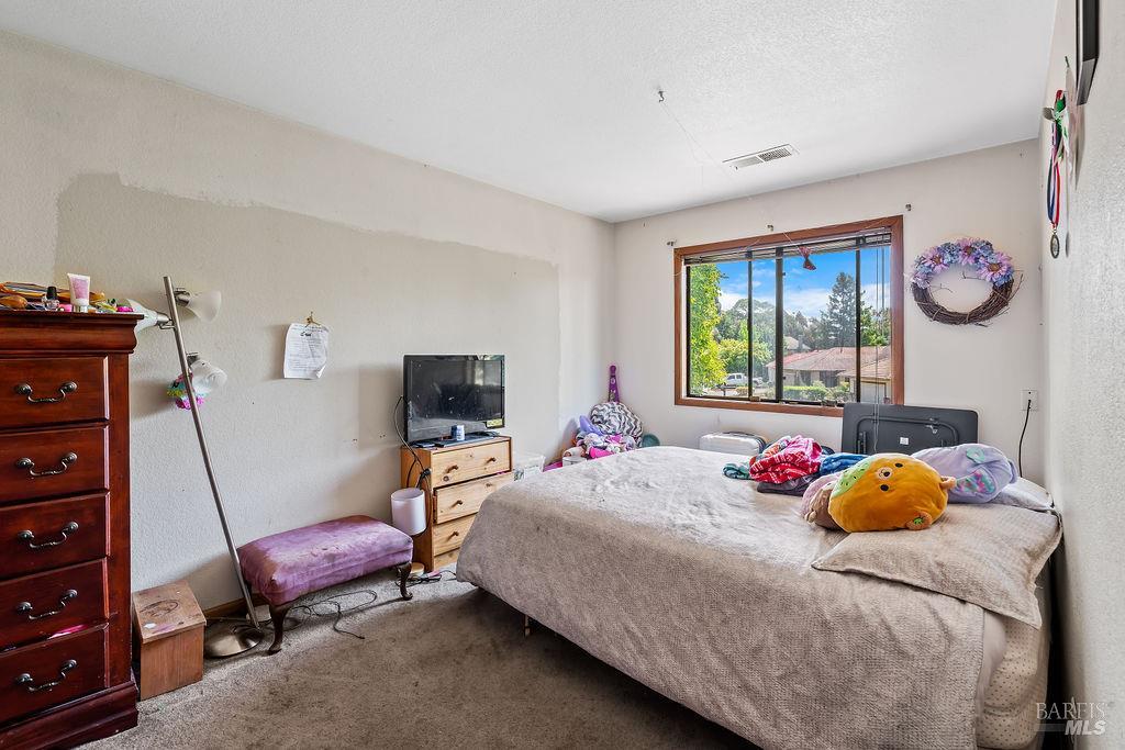 715 Placer Court Santa Rosa, CA 95401 - Photo 20 of 37 a bedroom with a bed and a window