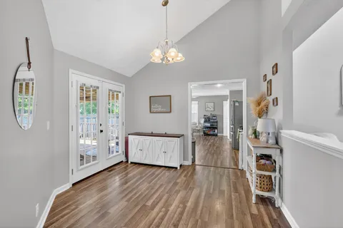 a view of a room with wooden floor and windows