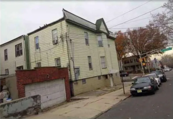 a couple of cars parked in front of a house