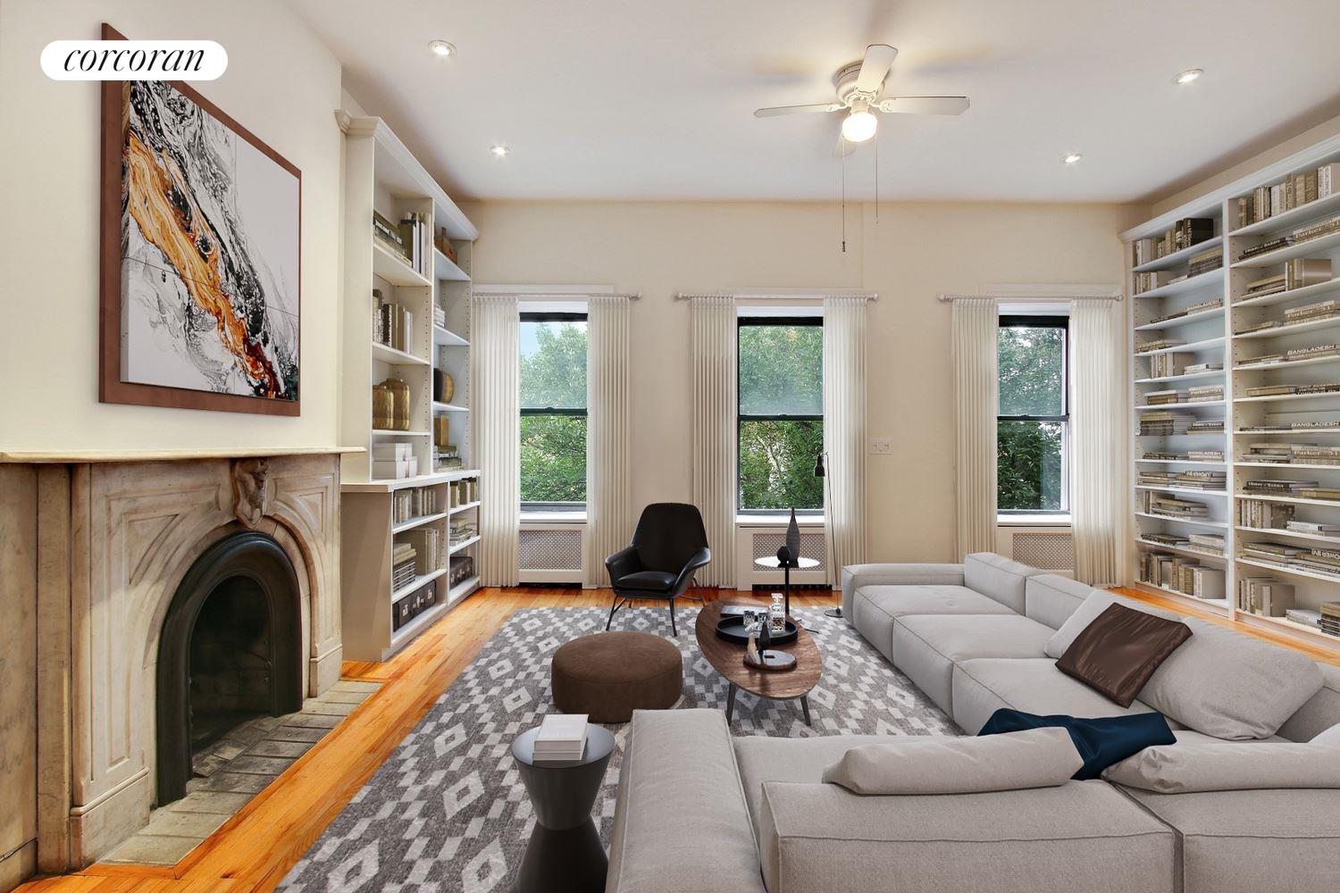 a living room with furniture a large window and a fireplace