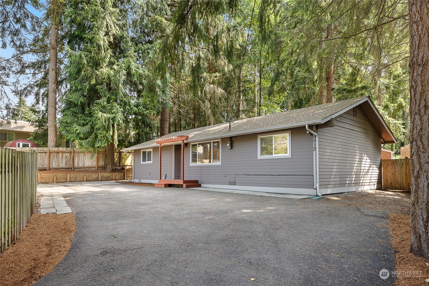 9512 Edmonds Way Edmonds, WA 98020 - Photo 1 of 24 a view of a house with a large tree and wooden fence