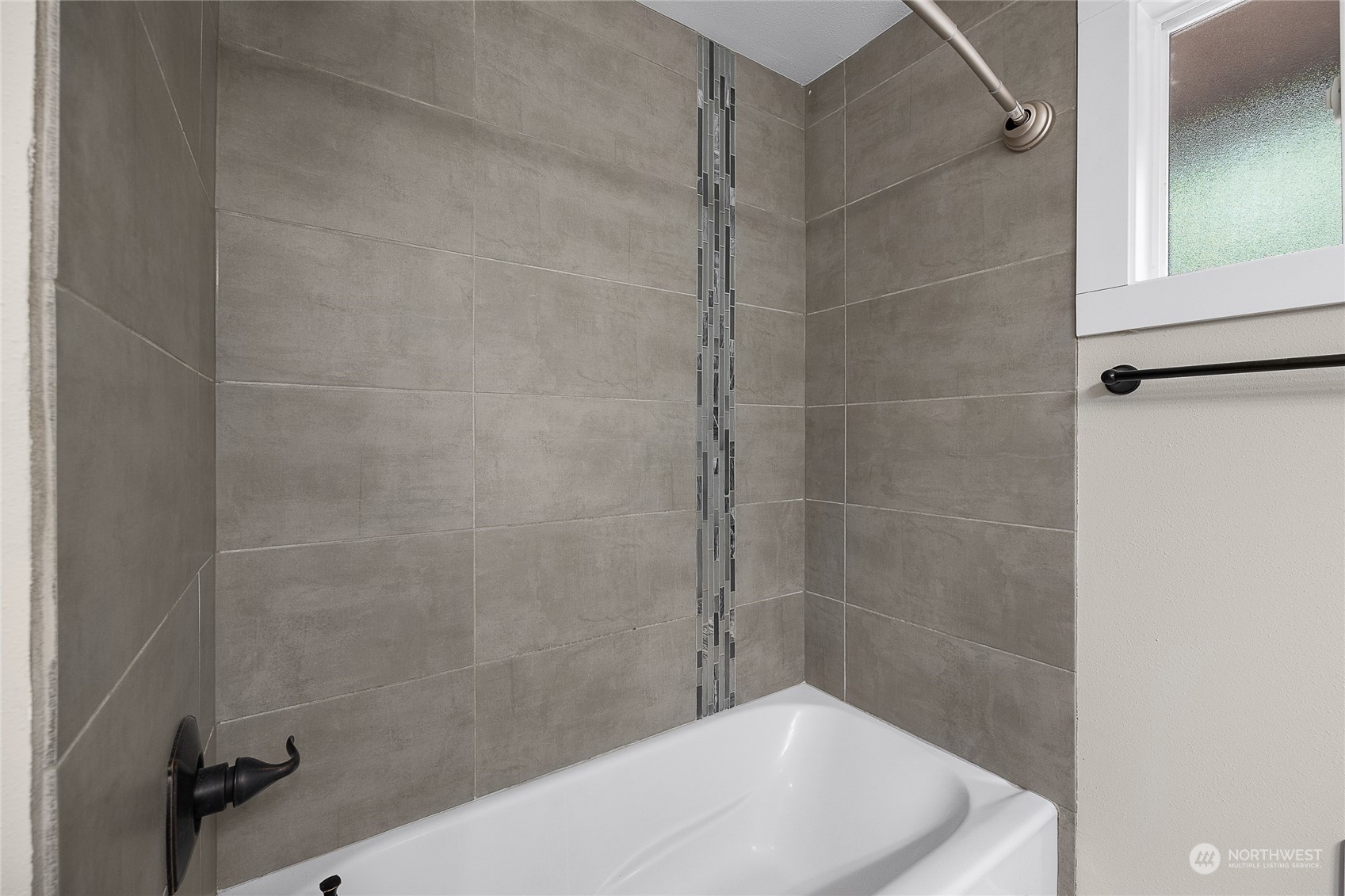 9512 Edmonds Way Edmonds, WA 98020 - Photo 17 of 24 a bathroom with a bathtub and a shower