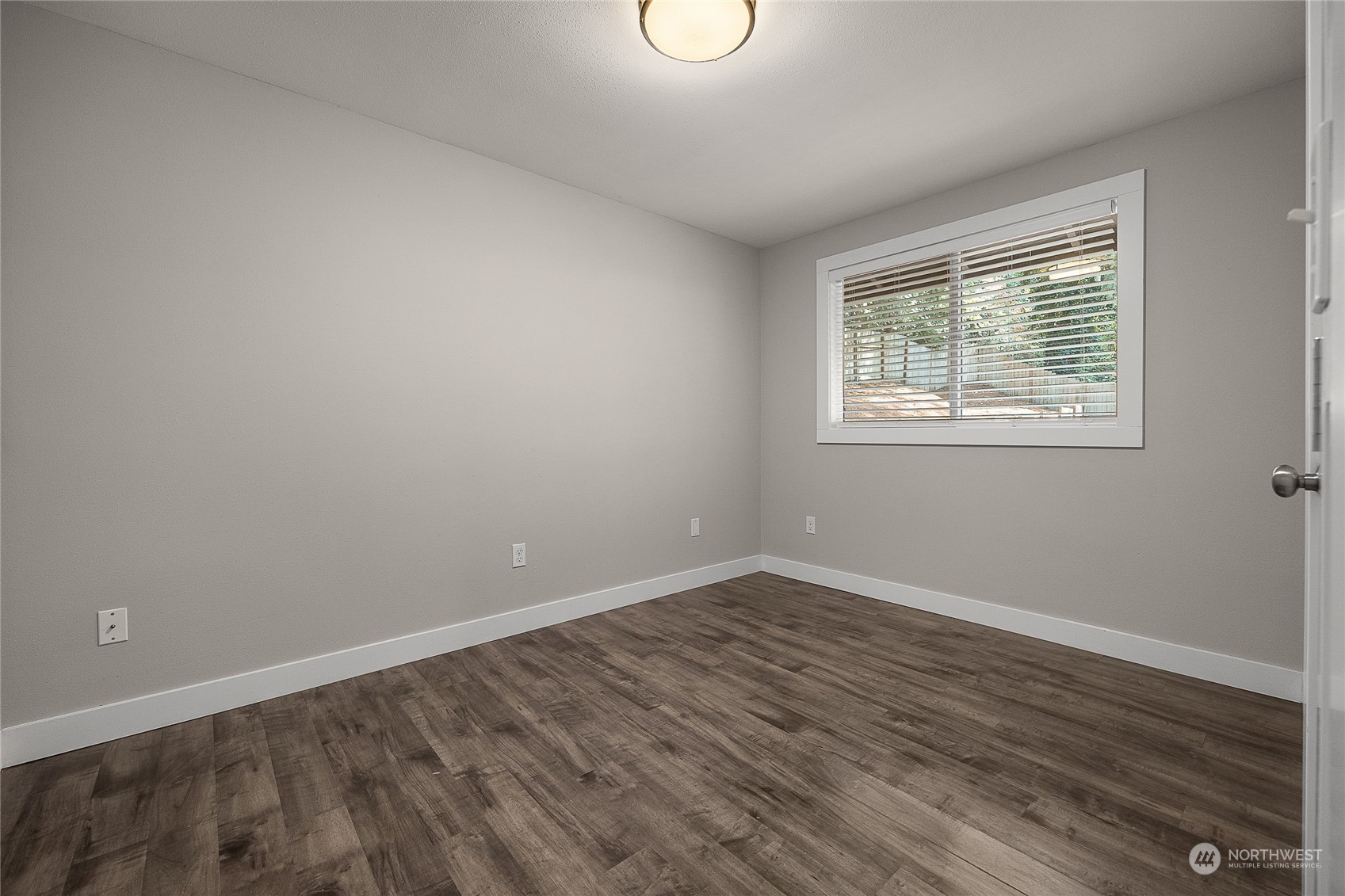 9512 Edmonds Way Edmonds, WA 98020 - Photo 19 of 24 a view of an empty room with wooden floor and a window