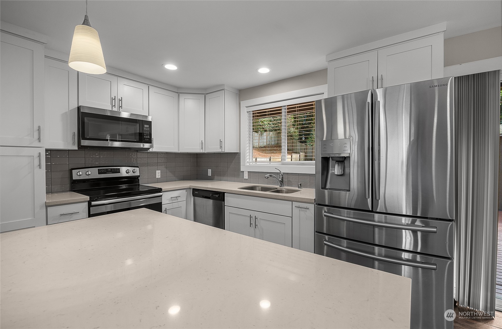 9512 Edmonds Way Edmonds, WA 98020 - Photo 8 of 24 a kitchen with a refrigerator and a stove top oven