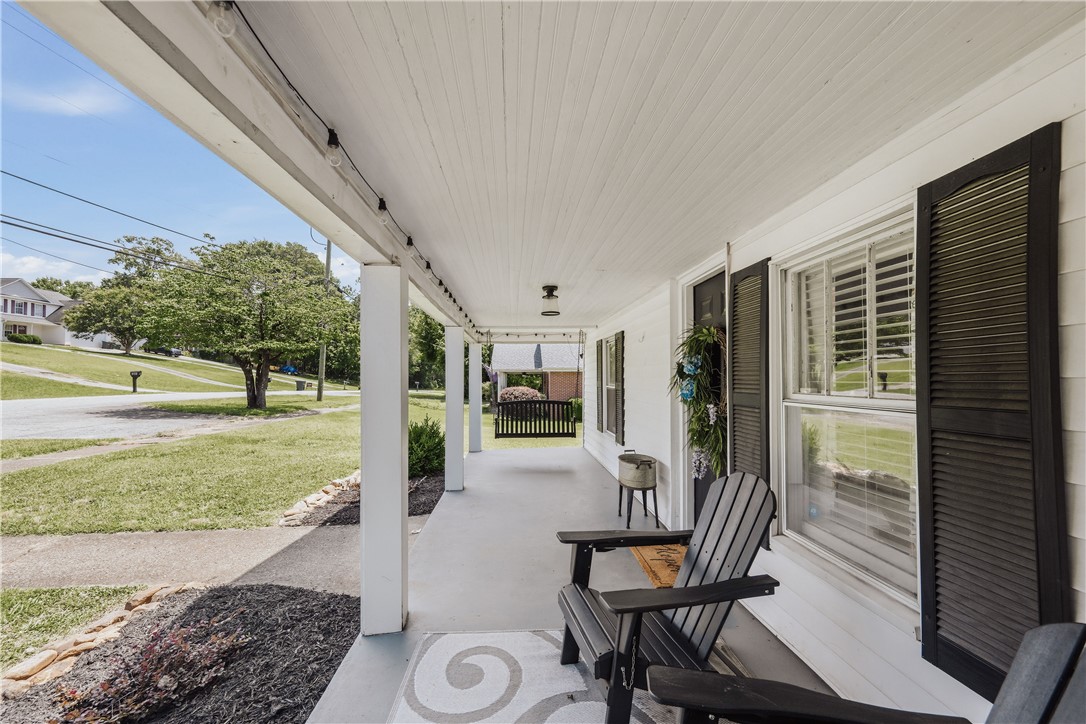 310 North Chestnut Street Seneca, SC 29678 - Photo 3 of 30 A classic front porch with ample space offers welcoming curb appeal and neighborhood views.