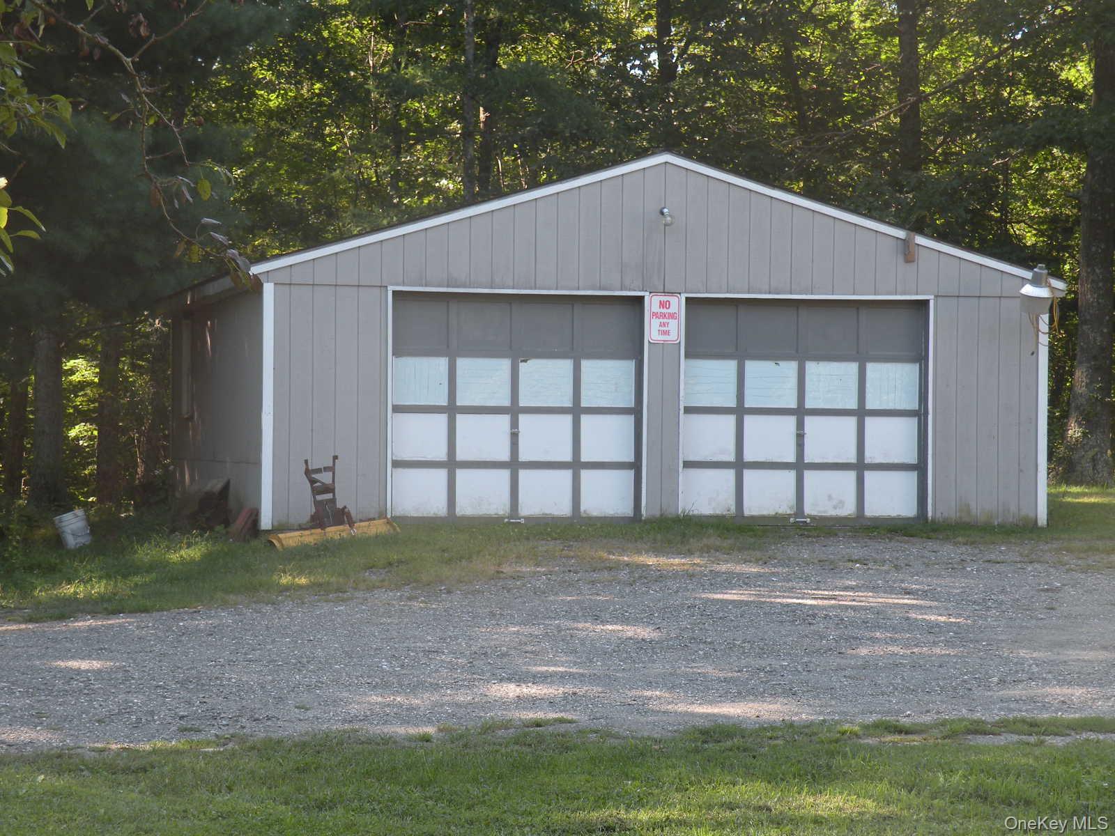 618 Bean River Road Millerton, NY 12546 - Photo 4 of 16 a view of a house with a yard and garage