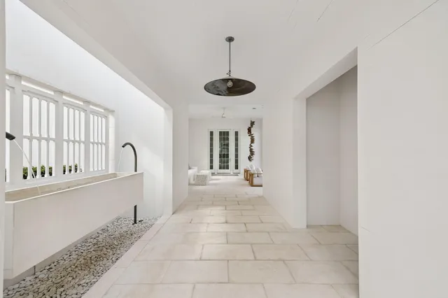 a living room with furniture and floor to ceiling windows