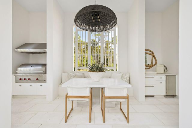 a living room with furniture and view of kitchen