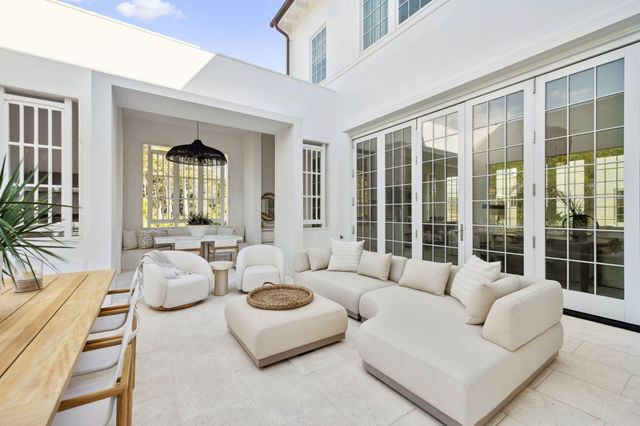 a view of a dining room with furniture and a potted plant