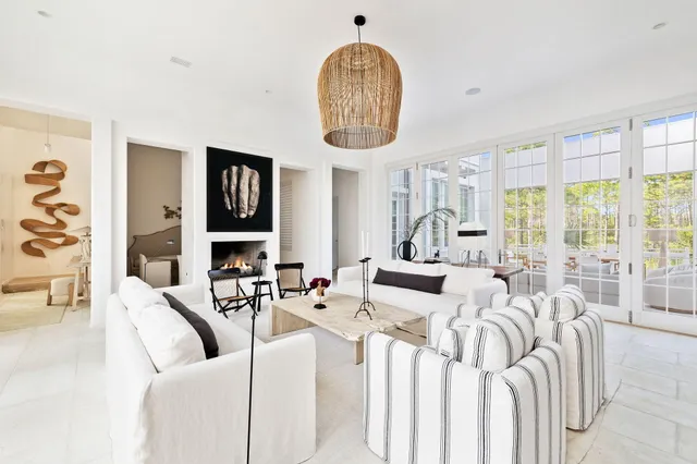 a living room with furniture chandelier and a large window