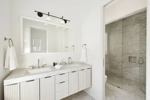 a bathroom with a sink toilet and shower