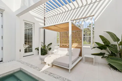 a front view of a house with a garden