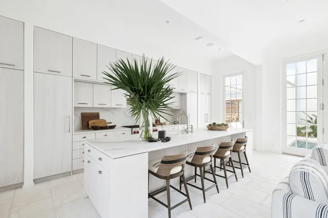 a kitchen with appliances a sink and cabinets