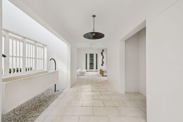 a living room with furniture and floor to ceiling windows