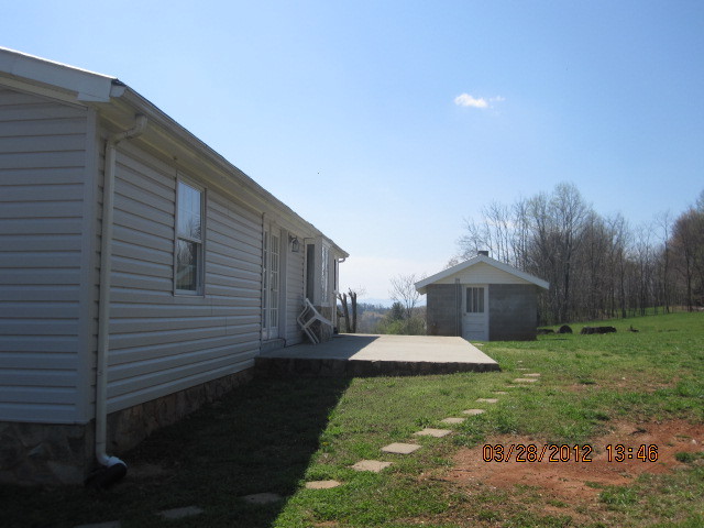 7154 Dry Hill Road Ferrum, VA 24088 - Photo 4 of 12 a front view of a house with garden