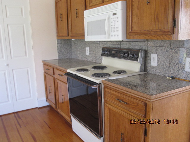 7154 Dry Hill Road Ferrum, VA 24088 - Photo 8 of 12 a kitchen with granite countertop a sink stove and cabinets