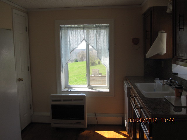 7154 Dry Hill Road Ferrum, VA 24088 - Photo 9 of 12 a kitchen with a sink cabinets and a window