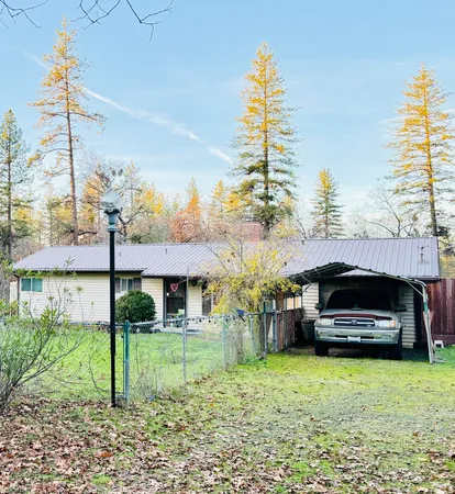 a front view of a house with a garden and plants