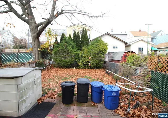 a view of a patio with table and chairs and wooden fence