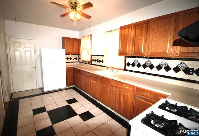 a kitchen with a sink cabinets and window