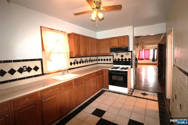 a kitchen with a stove a refrigerator and a sink