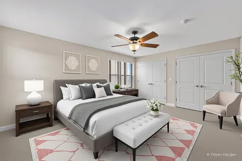 a spacious bedroom with a bed and a chair