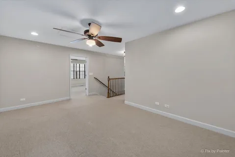en empty room with ceiling fan and window