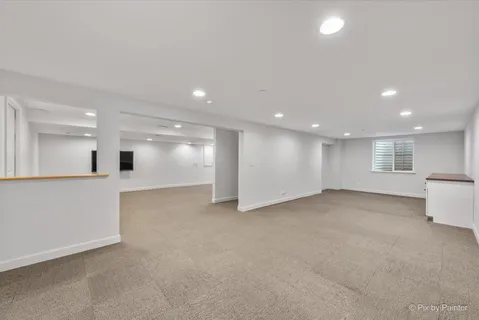 a view of a big room with kitchen and windows