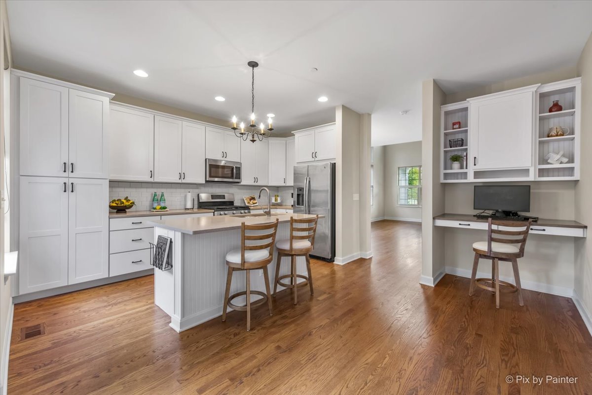 2122 Shermer Road Glenview, IL 60026 - Photo 3 of 37 a kitchen with white cabinets and stainless steel appliances