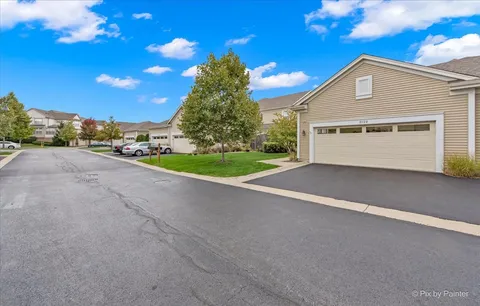 a view of a house with a yard and garage